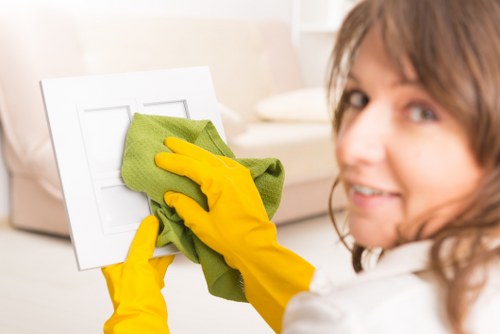 Local cleaner working in a Finchley flat with careful attention to floors and surfaces